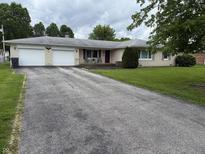 Charming single-story home with a large driveway and attached two-car garage at 5585 Gallagher Dr, Greenwood, IN 46142
