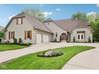 Beautiful exterior view of home showcasing the brick facade, wooden shutters, and well-manicured lawn at 5786 E Fall Creek Pkwy N Dr, Indianapolis, IN 46226