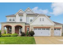 Charming two-story home with brick and stone accents, complemented by a well-manicured lawn at 6078 Hardwick Dr, Whitestown, IN 46075