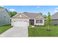 Charming single-story home featuring a brick facade, attached garage, and well-maintained lawn at 6609 Dunkirk Dr, McCordsville, IN 46055