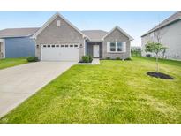Charming single-Gathering home featuring a two-car garage, well-maintained lawn, and inviting front entrance at 6847 Cardiff Dr, McCordsville, IN 46055
