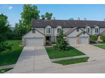 Charming townhome exterior with well-manicured lawn and attached one car garage at 7155 Sea Pine Dr, Indianapolis, IN 46250