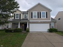 Charming two-story home featuring a two-car garage, brick accents, and neutral-toned siding at 8354 Fieldfare Way, Indianapolis, IN 46237