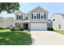 Traditional two-story home with a large two car garage and beautiful front lawn at 8354 Fieldfare Way, Indianapolis, IN 46237