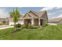 Charming single-story home with manicured lawn, covered porch, and inviting curb appeal at 9166 Lieven St, Avon, IN 46123