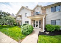 Inviting home exterior featuring a well-manicured lawn and charming architectural details at 931 Wickham Ct # 101, Carmel, IN 46032