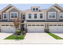 Attractive townhome with a two-car garage and well-maintained landscaping at 9583 Beckett St, Avon, IN 46123