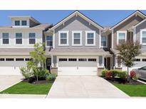 Charming townhome with attached two-car garage and manicured front lawn at 9604 Beckett St, Avon, IN 46123
