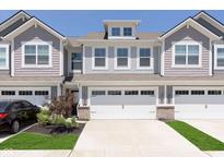 Charming townhome with a two-car garage, well-maintained landscaping, and inviting curb appeal at 9652 Beckett St, Avon, IN 46123