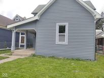 Gray two-story home featuring a covered porch and horizontal siding at 1322 S Belmont Ave, Indianapolis, IN 46221