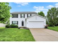 Charming two-story home with a well-manicured lawn and attached two-car garage at 14638 Deerwood Dr, Carmel, IN 46033
