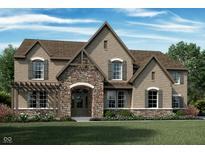 Stunning brick two-story home boasts a stone entryway, arched windows, detailed trim, and a welcoming front porch at 1475 Old Hickory Ln, Westfield, IN 46074