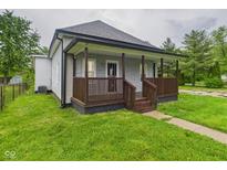 Charming home featuring a welcoming front porch, updated siding, and a well-maintained lawn at 1520 E Kirk St, Muncie, IN 47303