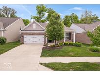 Charming single-Gathering home featuring a manicured lawn, two-car garage, and traditional architecture at 16573 Cava Dr, Fishers, IN 46037