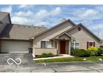 Charming single Gathering home features a well-maintained lawn and an attached two-car garage at 3016 Wildcat Ln, Indianapolis, IN 46203