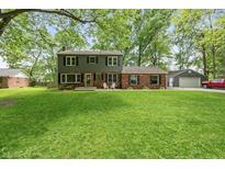 Charming two-story home with a well-manicured lawn and a combination of brick and siding exterior at 3333 Melbourne S Rd, Indianapolis, IN 46228