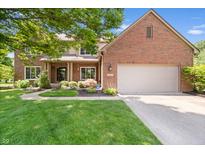 Beautiful brick two-story home with a well-manicured lawn and mature landscaping at 3823 Brigade Cir, Carmel, IN 46032