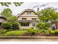 Charming two-story home with brick facade, awning-covered windows, and a well-manicured front lawn at 3840 N Washington Blvd, Indianapolis, IN 46205