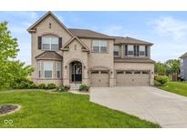 Charming two-story brick home with three-car garage and well-manicured lawn at 4061 Secretariat Ln, Bargersville, IN 46106