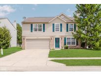 Charming two-story home with blue shutters, a well-maintained lawn, and an attached two-car garage at 6703 Wimbledon Dr, Zionsville, IN 46077