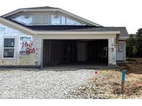 Unfinished home showcasing garage and construction, offering a glimpse of a new build with a stone driveway and white trim at 7346 Broadview Ln, McCordsville, IN 46055