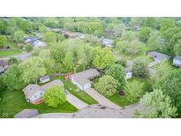 Aerial view of a home featuring a well-maintained lawn and mature trees at 8206 Bull Run Ct, Indianapolis, IN 46227