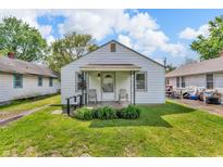 Charming single-story home featuring a cozy porch, well-kept lawn, and classic design at 1124 S Lockburn St, Indianapolis, IN 46241