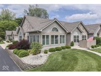 Charming home featuring a stone facade, manicured lawn, and well-kept landscaping at 1130 Deerbrook Trl, Greenwood, IN 46142