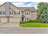 Inviting home featuring an attached garage, neutral siding, green lawn, and tasteful landscaping at 1139 Fernwood Way, Plainfield, IN 46168