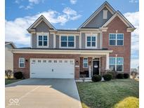 Charming two-story home with brick and gray siding, featuring a welcoming front entrance and a two-car garage at 1381 Avocet Dr, Greenwood, IN 46143