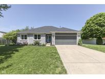 Charming single-story home featuring a well-manicured lawn, gray brick facade, and a two-car attached garage at 1480 E Jefferson St, Franklin, IN 46131