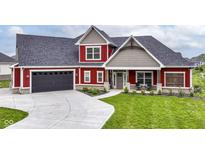 Inviting two-story home showcasing a well-manicured lawn and dark garage doors at 1595 N Blue Rd, Greenfield, IN 46140