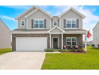 Charming two-story home with a brick and siding exterior, well-manicured lawn, and an attached two-car garage at 1893 Glenmoor Ct, Columbus, IN 47201