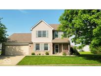 Charming two-story home with a well-manicured lawn, attached garage, and inviting front porch at 2 E Quail Wood Ln, Westfield, IN 46074