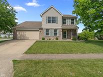 Inviting two-story home featuring a well-manicured lawn and attached two-car garage, with neutral siding and complementary shutters at 2 E Quail Wood Ln, Westfield, IN 46074