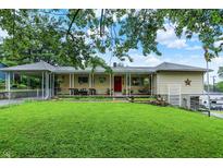 Charming ranch home with inviting front porch, lush lawn, and convenient carport at 313 E South St, Morristown, IN 46161