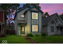 Charming two-story home with blue trim and a well-manicured lawn, perfect for a Gathering at 3658 Graceland Ave, Indianapolis, IN 46208