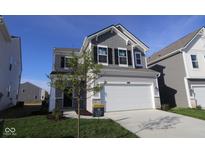 Two story home features a two car garage, grey siding, black shutters, and manicured lawn at 6223 Medina Spirit Dr, Indianapolis, IN 46237