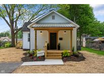 Charming renovated home featuring a cozy porch and well-manicured landscaping at 650 Overstreet St, Franklin, IN 46131