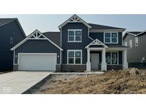 Two-story home featuring blue siding, white trim, and a two-car garage at 6551 Ambassador Dr, Plainfield, IN 46168