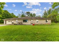 Charming single-story home with stone facade, attached garage, and a spacious front lawn at 6925 W State Road 128, Frankton, IN 46044