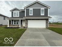 Two-story home featuring gray siding, white trim, and a two-car garage in a well manicured yard at 7605 Big Bend Blvd, Camby, IN 46113