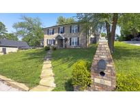 Charming two-story brick home with landscaped yard and inviting front entrance at 80 E College Ave, Martinsville, IN 46151