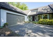 Charming home exterior with a stone accent wall, two car garage and a paved driveway at 858 Cedar Wood, Carmel, IN 46032
