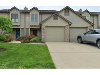 Charming townhome with well-manicured lawn and attached two-car garage at 9154 Sea Oats Dr, Indianapolis, IN 46250