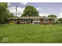 Charming single-story brick home with a large front yard and American flag at 1190 W Jefferson St, Franklin, IN 46131