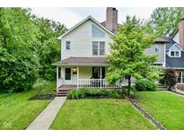 Charming two-story home with a front porch and well-maintained lawn at 1236 Central Ave, Indianapolis, IN 46202