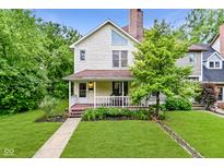 Charming two-story home featuring a cozy front porch, mature landscaping, and a well-maintained lawn at 1236 Central Ave, Indianapolis, IN 46202