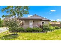 Charming bungalow home with a covered porch and well-maintained lawn at 1237 W State Rd 38, Pendleton, IN 46064