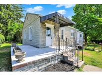 Charming single-story home with stone facade, covered entryway, and landscaped front yard at 1515 S Emerson Ave, Indianapolis, IN 46203